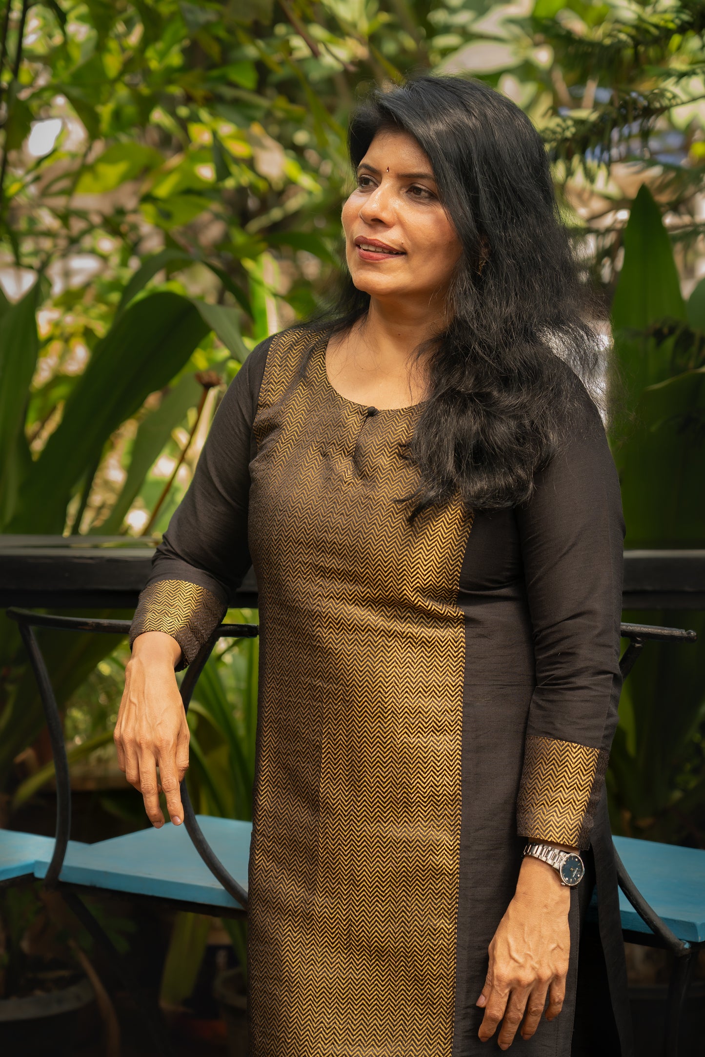 Long black cotton silk kurti with a round neck and small key button in front. Long sleeves with brocade borders.