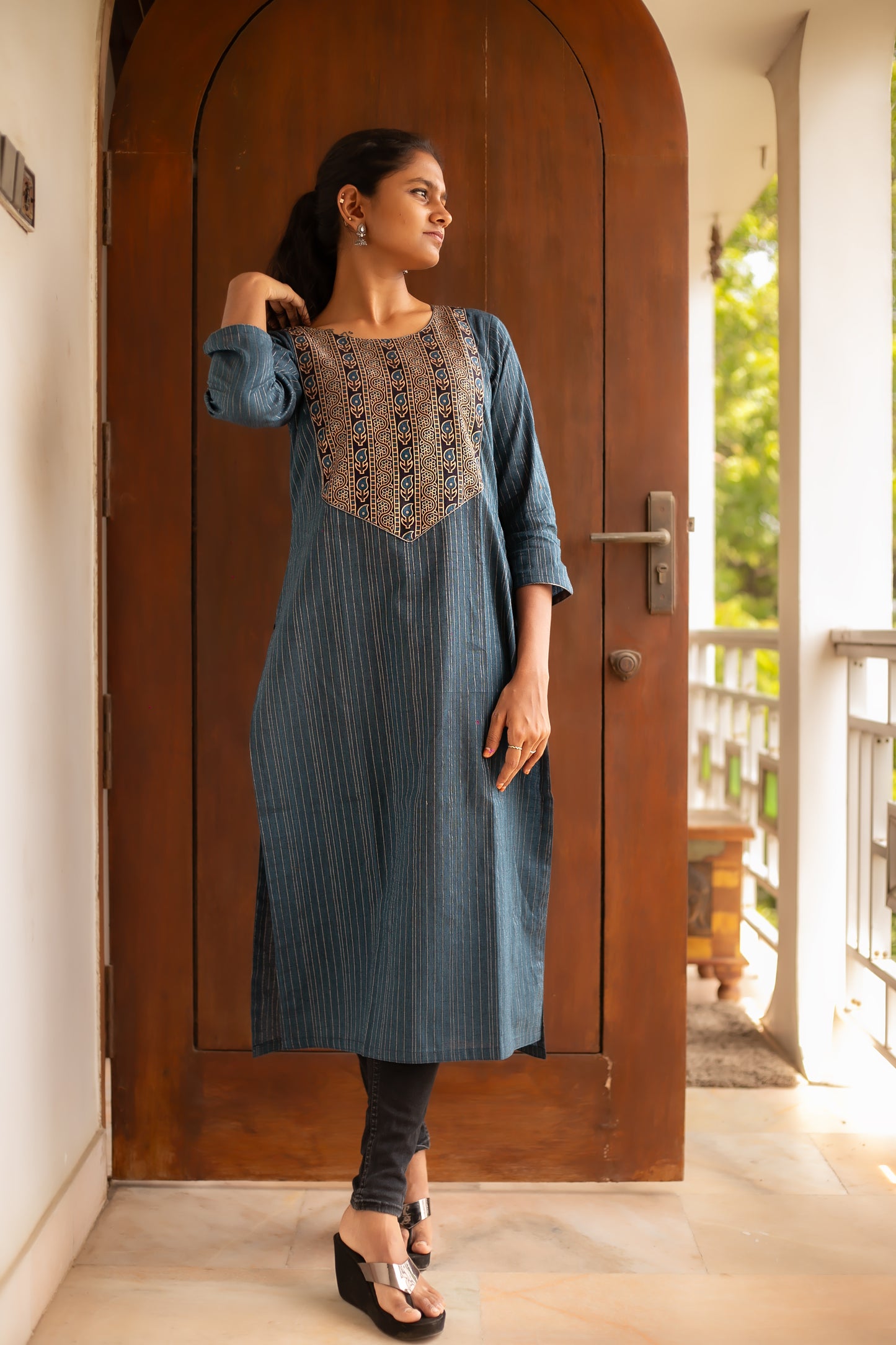 Solid blue designer kurti with delicate silver lines, enhanced with a paisley printed yoke. This cotton kurti is a dream for everyday wear.