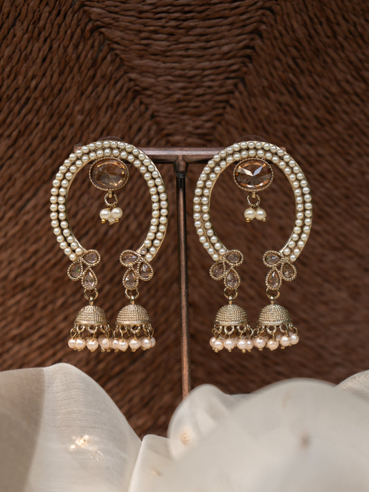Arch-shaped festive earring with pearl detailing, central gemstone, and two jhumka