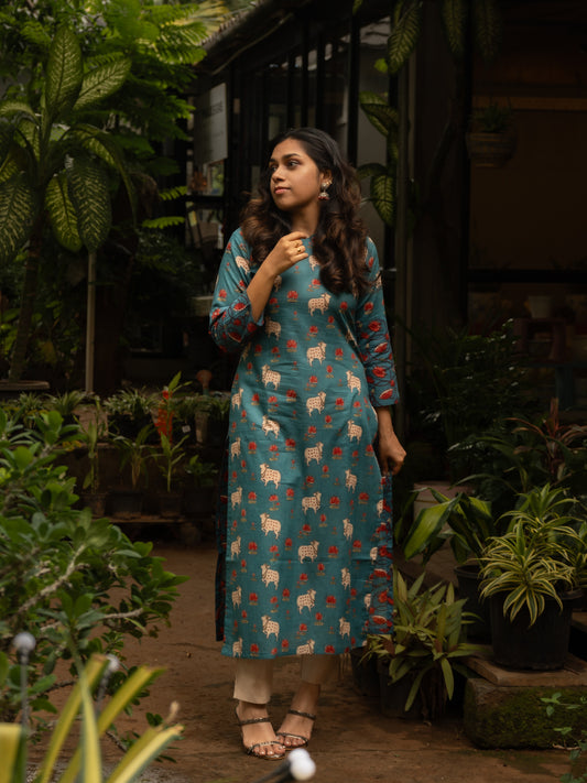 Blue cotton Pichwai kurti with curved bracket neckline, cow and lotus print, 3/4th sleeves, in-house stitched, front full view.