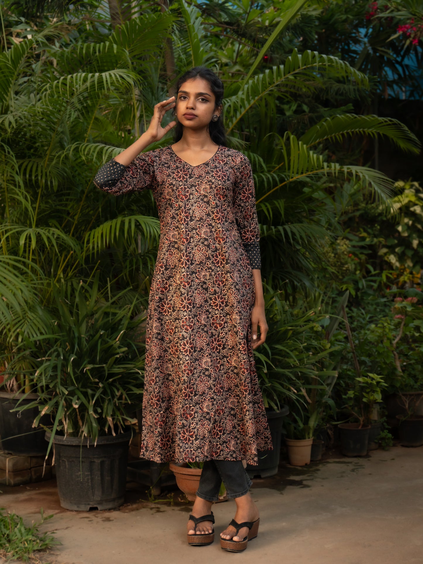 Front view of Bagru print A-line cotton kurti with V-neck and black silk sleeve borders