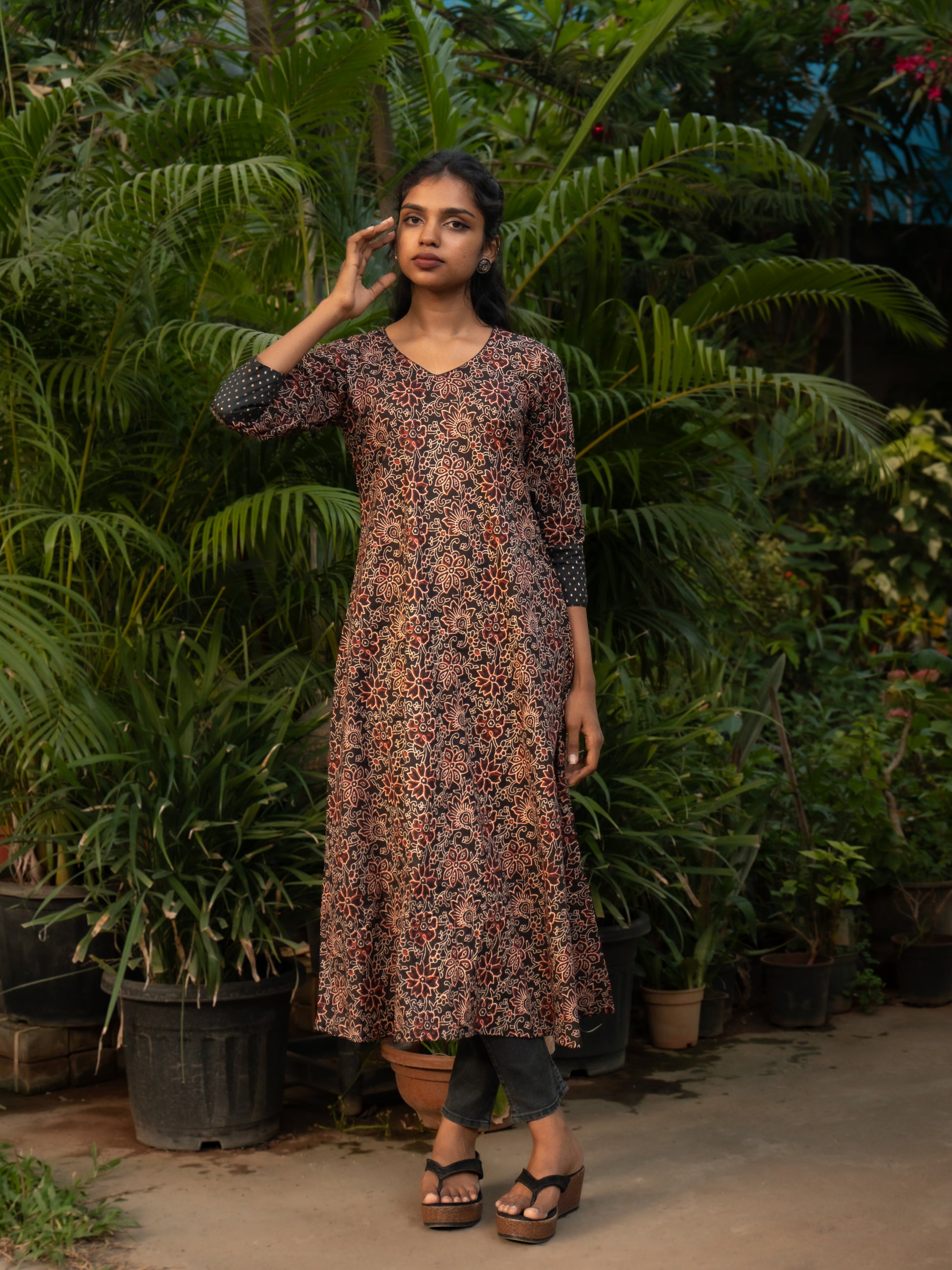 Front view of Bagru print A-line cotton kurti with V-neck and black silk sleeve borders