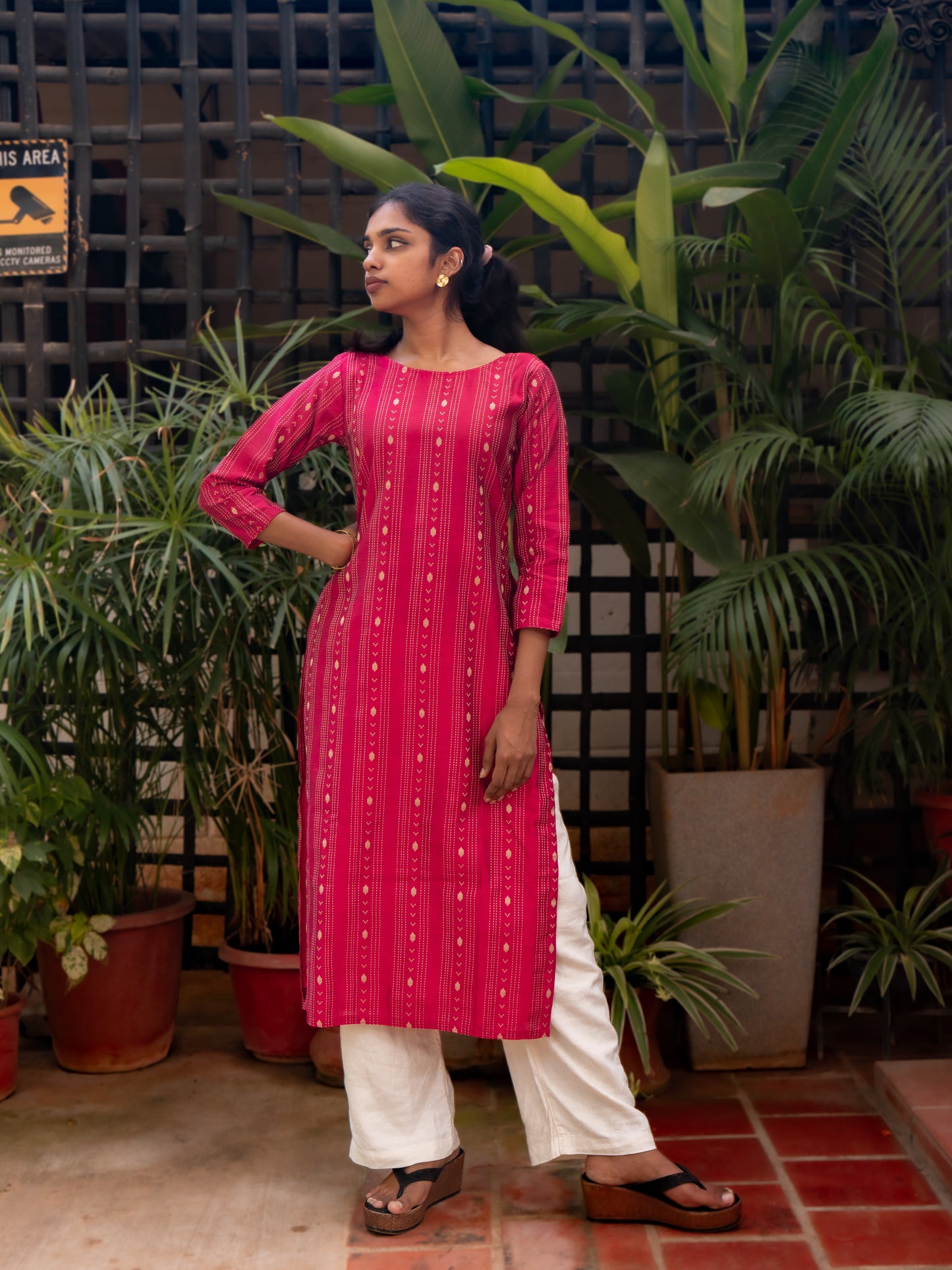 Side view of 3/4th sleeves and gold dot detailing on pink silk cotton kurti with inner lining from Sakyaa