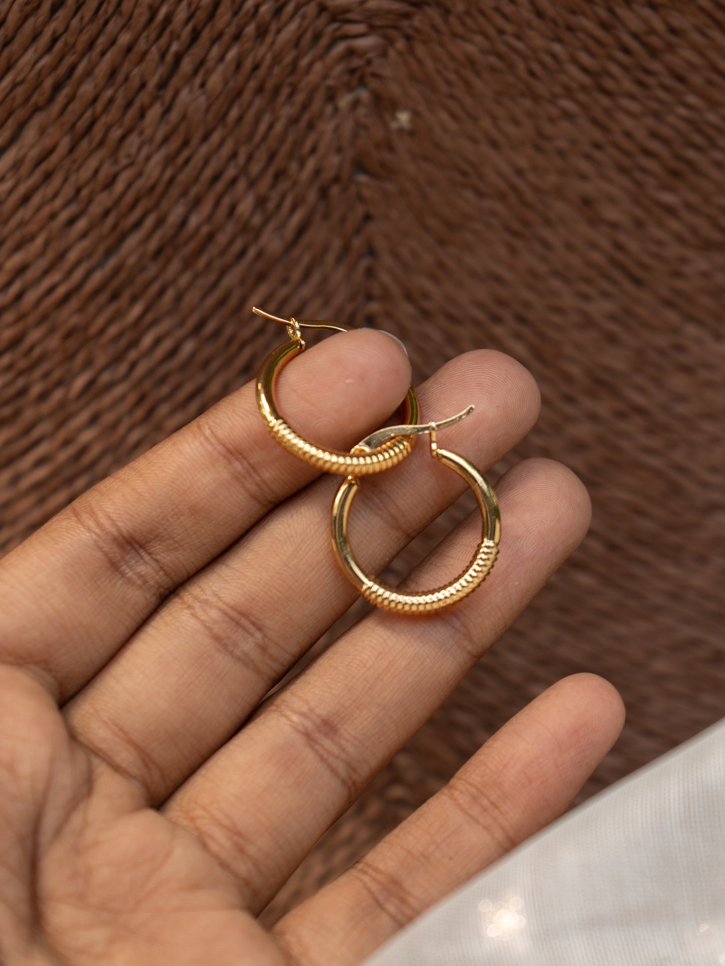 Woman wearing classic gold hoop earring with minimal self texture, perfect for everyday or festive wear