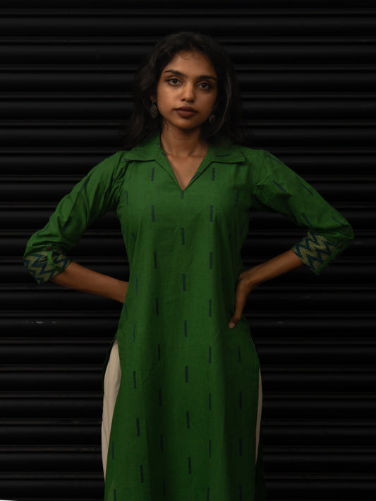 Mid-length view highlighting woven zig-zag sleeve borders and single-fold looped button detail on green handloom cotton kurti, handcrafted in-house.