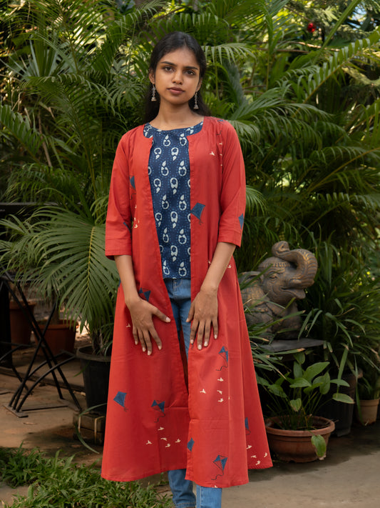 Front view of indigo cotton sleeveless top with red kite printed cotton cape jacket featuring A-line cut and 3/4th sleeves from Sakyaa.
