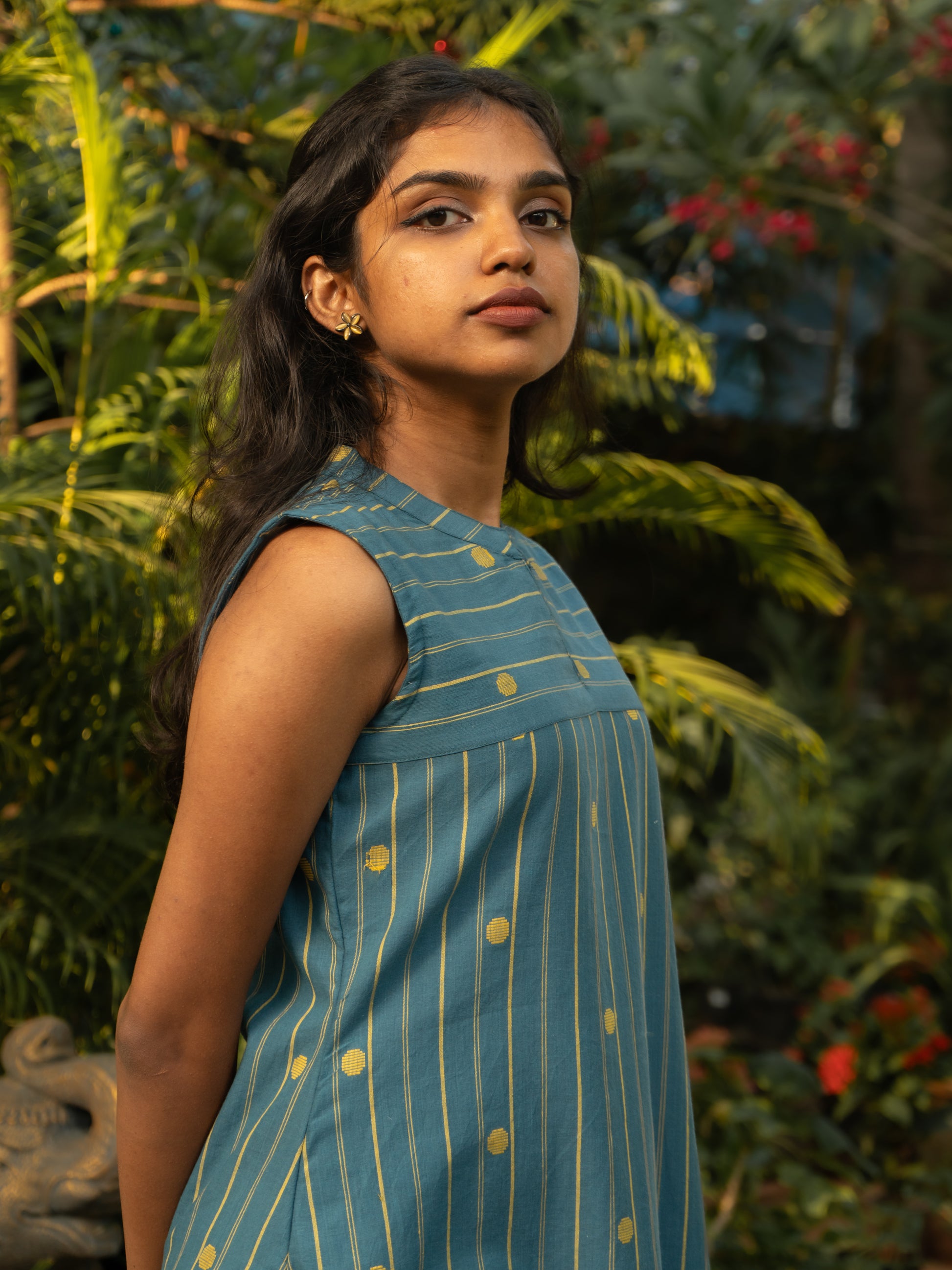 Styling of sleeveless light blue striped cotton kurti with yellow buttas, perfect for casual and office wear