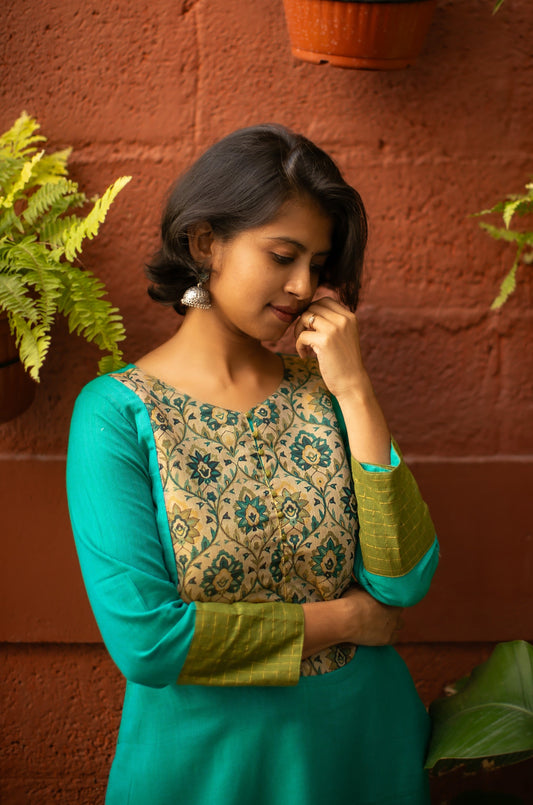 Lightweight teal cotton kurti with green sleeve borders detailed with light gold lines and a tissue yoke. Perfect for summer wear, office wear and casual wear.