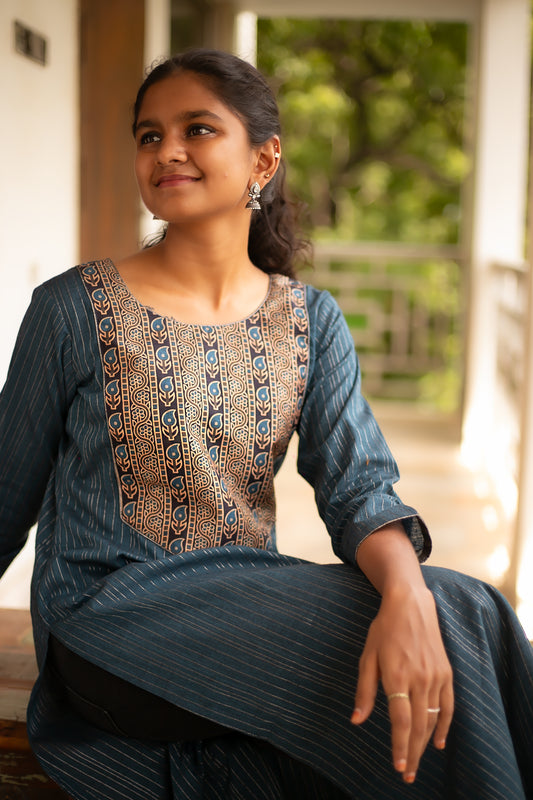 Solid blue designer kurti with delicate silver lines, enhanced with a paisley printed yoke. This cotton kurti is a dream for everyday wear. 