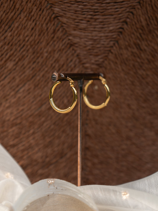 Classic gold hoop earring with subtle self-texturing, front view