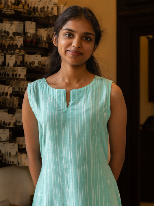 Close-up of A-line panels and split round neckline on pastel blue handloom cotton dress from Sakyaa.